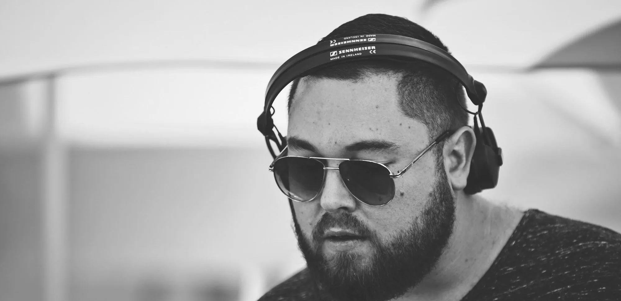 Dualitic behind the decks, wearing headphones