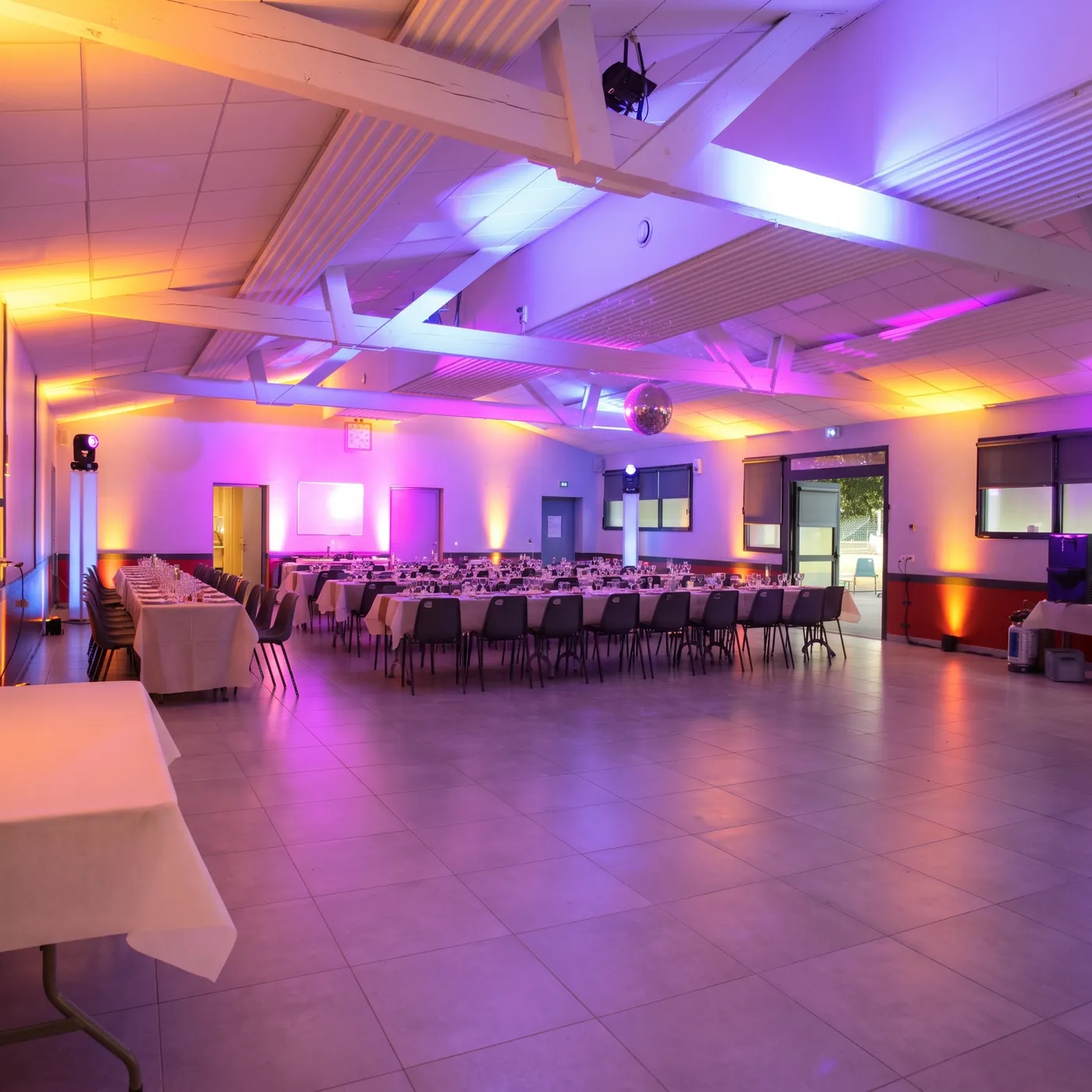 Wedding reception hall with ambient lighting set up by Dualitic